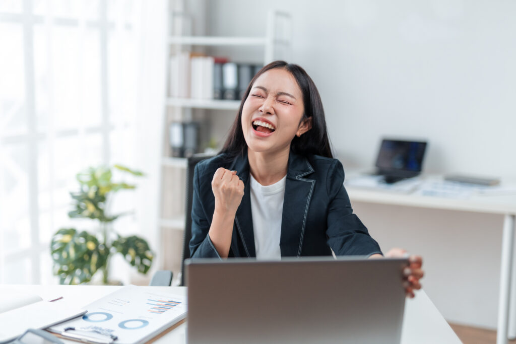 A young female, hired for an entry-level position, is celebrating.